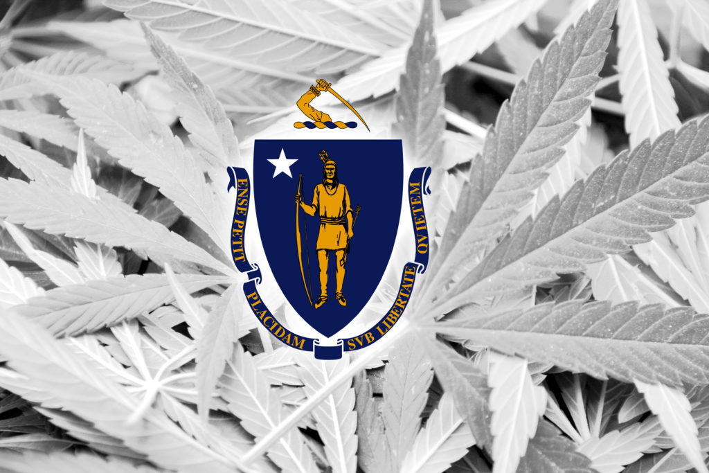 is weed legal in massachusetts? massachusetts flag over weed leaves